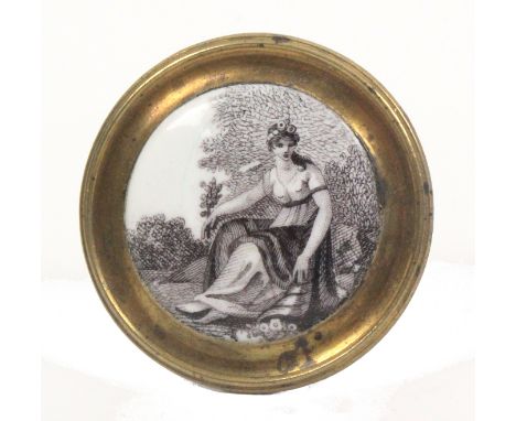 A late 18th Century English enamel mounted brass handle or curtain tie back, with a domed black and white enamel plaque of a 