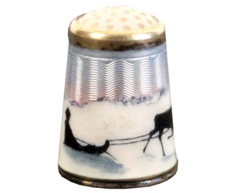 A Norwegian silver and enamel stone top thimble by Askel Holmsen depicting a reindeer pulling a sled with Sami in a winter la