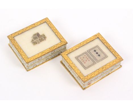 A pair of early 19th Century French cardboard boxes probably bonbonnieres, each rectangular with gold on cream decorated side