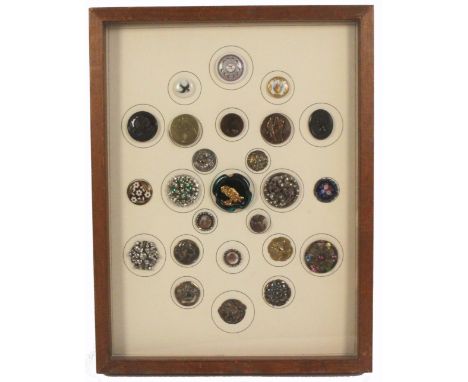 Buttons - a framed display of twenty five, including a domed enamel under glass with floral centre, three carved mother of pe