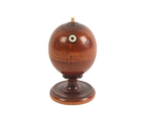 An attractive turned and stained boxwood wool ball or string box holder, turned pedestal on circular base, bone aperture and 