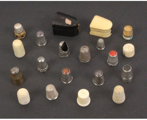 A collection of thimbles and two thimble cases, comprising five 19th Century ivory examples, eight silver examples including 