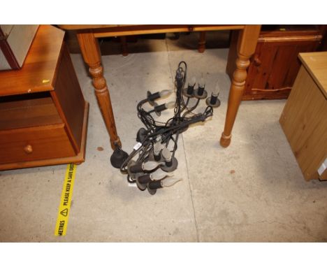 A pair of wrought metal pendant light fittings