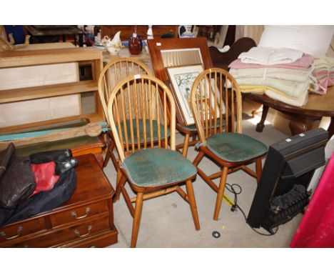 A set of four stick back kitchen dining chairs 