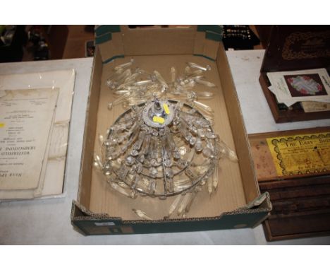 A three tier chandelier with glass prism drops 