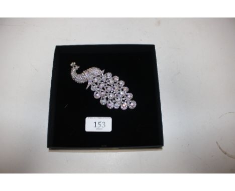 A large vintage brooch in the form of a peacock
