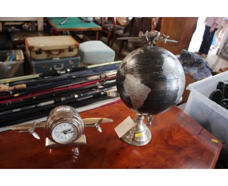 A clock in the form of an aeroplane; and a world globe with aeroplane decoration