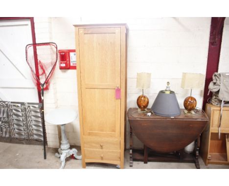 A modern light oak narrow cupboard fitted two drawers to base 
