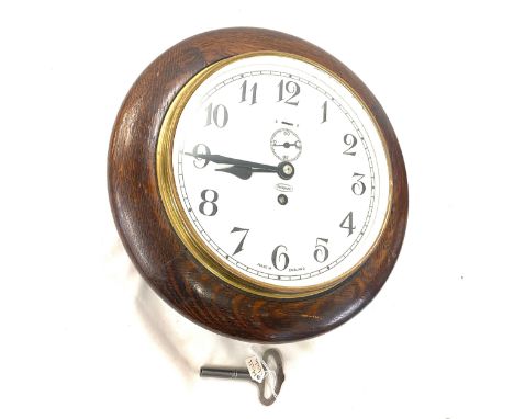 Vintage hall clock with key and pendulum, recently serviced and restored, approximate measurements: diameter 11.5 inches 