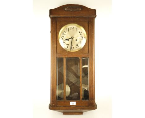 A 1930s oak cased wall clock. Eight day chiming movement to a single gong, with silver dial and Arabic numerals. Gong bracket