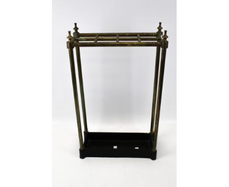 A vintage brass and cast iron stick umbrella stand. Of rectangular form with black painted cast iron base, brass sectioned to