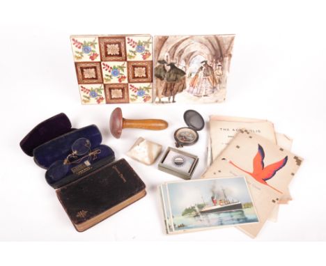 An assortment of vintage collectables. Including a pair of painted ceramic tiles, a common prayer book, pocket compass, a mot
