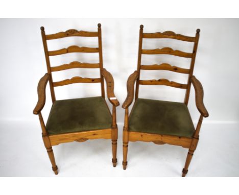 A pair of pine ladder back open armchairs. With green upholstered seat, on turned and tapering supports. H102cm