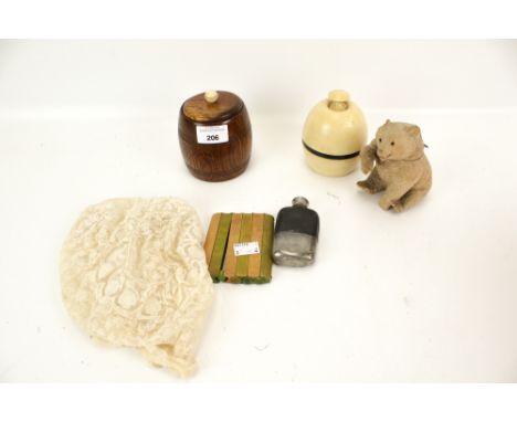 An assortment of collectables. Including a flintless table lighter, carved bear inkwell, lace bonnet, etc.