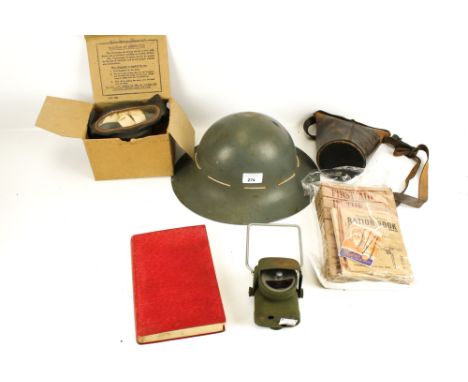 A group of assorted WWII collectables. Including a helmet, lamp, etc.