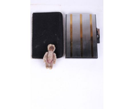 A Schuco monkey perfume bottle and an Art Deco compact. The early 20th century German Schuco monkey scent bottle with removab