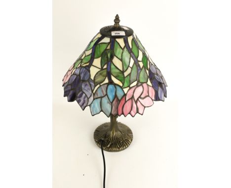 A contemporary Tiffany style lamp. With a cast metal frame and leaded glass shade with floral details, H51cm
