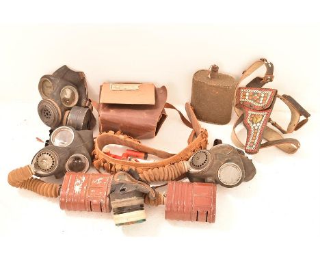 A quantity of various military items including gas masks, hunting belt, holster, etc; Height 19cm x Width 21cm 