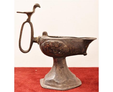 A Khorasan oil lamp on spreading trumpet foot, with hexagonal base, the flat topped rounded body of drop form extruded into a