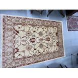 Rugs & Carpets: Modern weave rug, ivory colour highlighted with reds, blues and green. 81ins. x