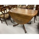 Early 19th cent. Mahogany oval dining table with two flaps on a baluster shaped column and four