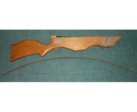 Modern wooden constructed cross bow with carved spring metal bow