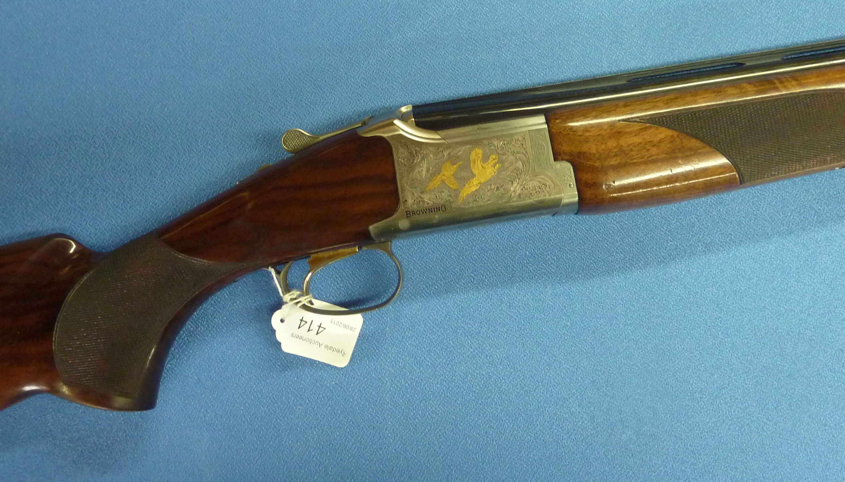 Browning 12 bore over and under ejector shotgun with gold colour single ...