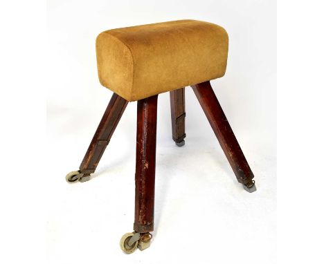 A vintage pommel horse raised on wooden legs, two with castors, 103 x 99 x 81cm