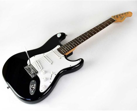 CRUZER BY CRAFTER; a black electric guitar with white scratch board and three single coil pick-ups, in a Stagg soft case.