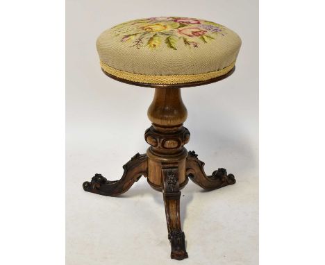 A Victorian rosewood piano stool, the tapestry covered seat above turned column, to carved tripod base, height 48cm.