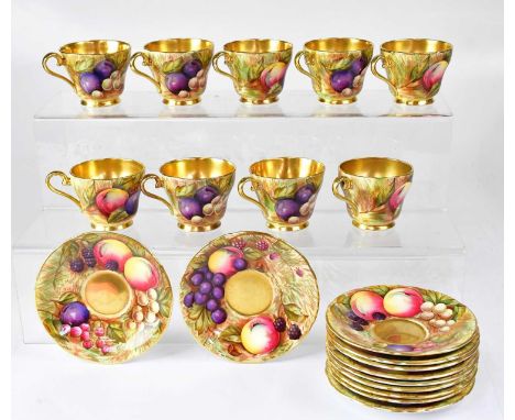 AYNSLEY; a group of gilt-heightened coffee cups and saucers painted with fruit, comprising nine cups and eleven saucers (20).