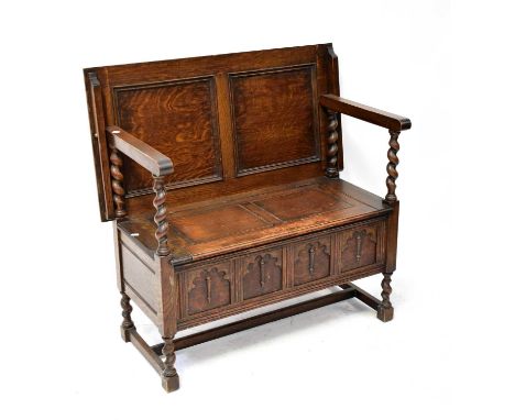 A 1930s oak monk's bench with lift-up seat, on barley twist legs with stretchers, 98 x 99cm.Condition Report: Knocks, scratch