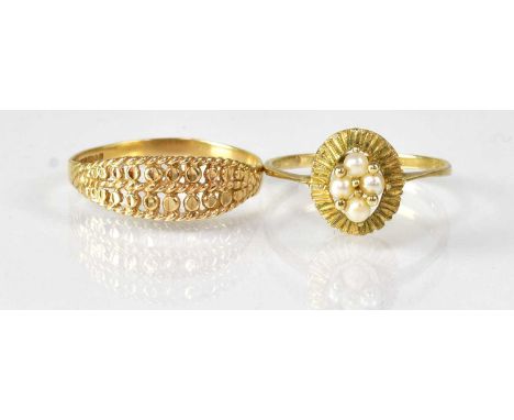 Two 9ct yellow gold rings, comprising an example with textured and pierced detailing, size R, and an example set with four se