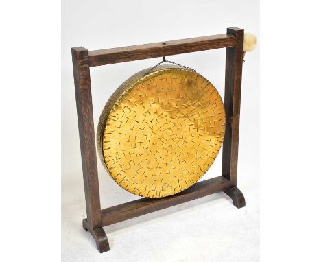 A vintage brass dinner gong in an oak frame, with beater, diameter 62cm, frame 88 x 78cm.