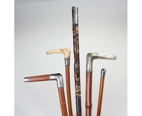 Silver capped riding crop, together with two silver capped canes, a silver and horn riding crop and a bamboo walking stick, (