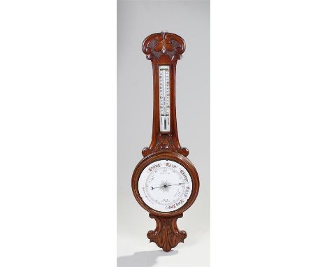 Victorian Aneriod barometer, the oak case with thermometer above a carved flower, weather gauge and carved acanthus leaf base