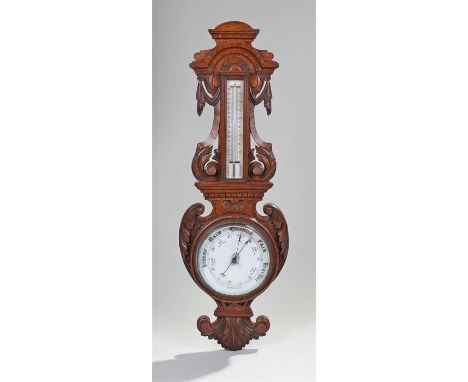 Victorian barometer, the arched top above a thermometer and weather gauge with shaped and carved frame, 97cm high