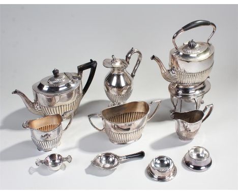 Silver plated teapot on stand, the gadrooned teapot above a base with burner and lion paw feet, together with a three piece t