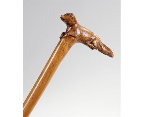 19th Century carved dog walking stick, the carved laying dog forming the handle above the shaft, 88cm high