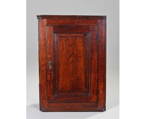 18th Century oak corner cabinet, the concave cornice above a fielded panel door enclosing a shaped shelf, 59cm x 28cm x 82cm