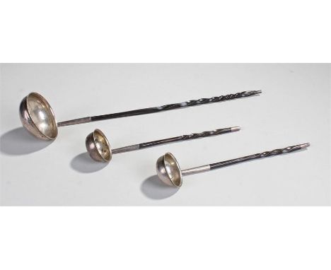 Three 19th Century baleen toddy ladles, to include a pair of white metal toddy ladles and a larger toddy ladle, (3)