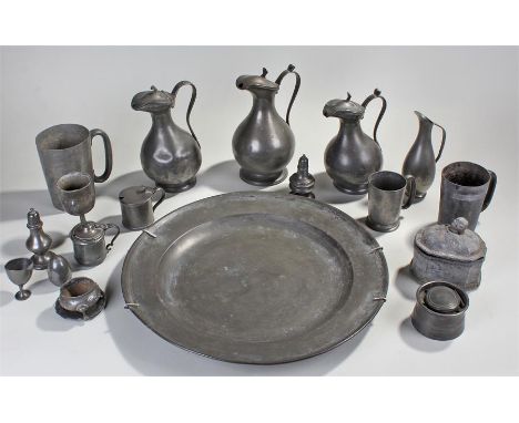 Collection of pewter to include: a charger, three lidded ewers, a jug, three tankards, an inkwell, a tea caddy and condiments