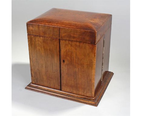 Victorian oak tantalus, the hinged top opening to reveal a mirror back, three decanters, five glasses, a pottery tobacco cadd
