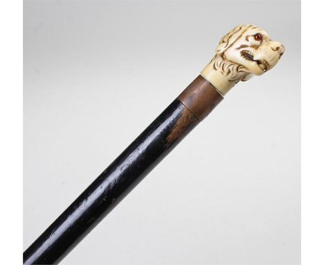 Victorian carved ivory dog head walking stick, carved with long ears, a glass inset eye above an ebonised cane, 88cm high