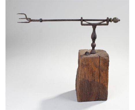 18th Century toasting fork, the rod with a spiked end to the baluster column on a block, 36cm long