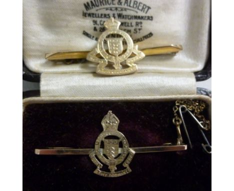 A gold coloured metal box brooch, bearing the engraved and pierced emblem of the Royal Army Ordnance Corp. stamped 9ct; and a
