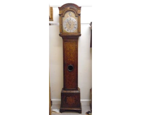 A mid 18thC walnut and marquetry longcase clock, the hood having an arched top, a blind fret carved frieze and turned pillars