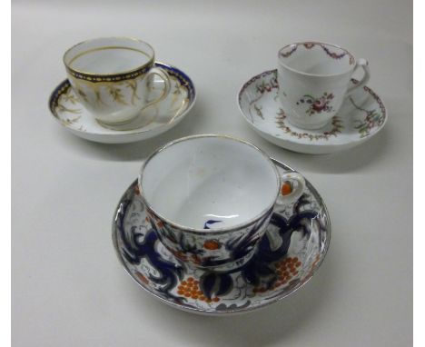 Three dissimilar late 18thC New Hall porcelain tea cups and saucers, one having a ring handle, decorated in silvered cobalt b