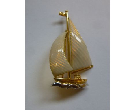A 9ct bi-coloured and translucent off white enamel brooch, fashioned as a yacht under sail