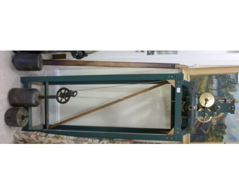 An Edwardian turret clock mechanism with a pendulum inscribed J W Benson, Ludgate Hill, 1904, on a green painted iron stand  